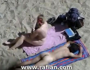 African and milky girls sunbathing on naked beach